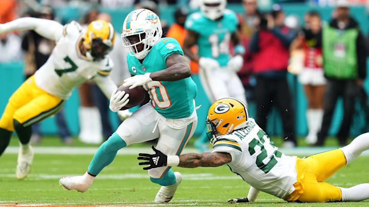 Miami Dolphins wide receiver Tyreek Hill (10) runs with the ball against Green Bay Packers cornerback Jaire Alexander in 2022. Miami Dolphins wide receiver Tyreek Hill (10) runs with the ball against Green Bay Packers cornerback Jaire Alexander in 2022.