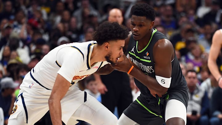 Apr 18, 2026; Denver, Colorado, USA; Denver Nuggets forward Cameron Johnson (23) is defended by Minnesota Timberwolves guard Anthony Edwards (5) during the first half in game one of the first round of the 2026 NBA Playoffs at Ball Arena.