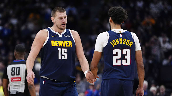Dec 15, 2025; Denver, Colorado, USA; Denver Nuggets forward Cameron Johnson (23) and center Nikola Jokic (15) in the second quarter against the Houston Rockets at Ball Arena. Mandatory Credit: Ron Chenoy-Imagn Images