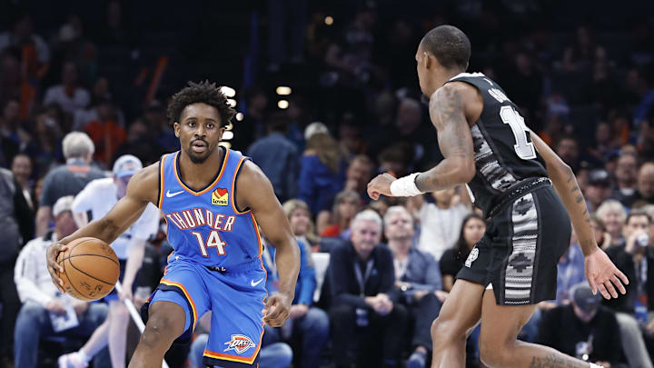 Apr 10, 2024; Oklahoma City, Oklahoma, USA; Oklahoma City Thunder forward Adam Flagler (14) drives to the basket against San Antonio Spurs guard Jamaree Bouyea (15) during the second half at Paycom Center. Mandatory Credit: Alonzo Adams-Imagn Images