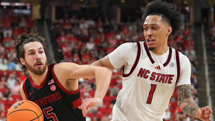 Mar 7, 2026; Raleigh, North Carolina, USA;  Stanford Cardinal guard Benny Gealer (5) controls the ball around NC State Wolfpack forward Darrion Williams (1) during the second half at Lenovo Center. Mandatory Credit: Zachary Taft-Imagn Images