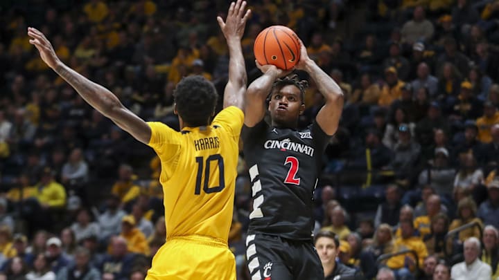 Feb 19, 2025; Morgantown, West Virginia, USA; Cincinnati Bearcats guard Jizzle James (2) shoots a jumper over West Virginia Mountaineers guard Sencire Harris (10) during the second half at WVU Coliseum. Mandatory Credit: Ben Queen-Imagn Images Feb 19, 2025; Morgantown, West Virginia, USA; Cincinnati Bearcats guard Jizzle James (2) shoots a jumper over West Virginia Mountaineers guard Sencire Harris (10) during the second half at WVU Coliseum. Mandatory Credit: Ben Queen-Imagn Images