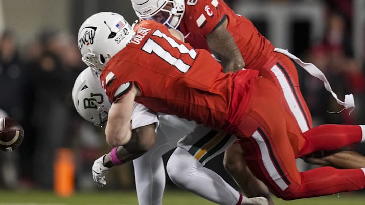 Oct 25, 2025; Cincinnati, Ohio, USA;  Baylor Bears tight end Michael Trigg (1) is unable to hold on to a catch as he is tackled by Cincinnati Bearcats linebacker Jake Golday (11) and defensive back Tre Gola-Callard (6) in the second half at Nippert Stadium. 