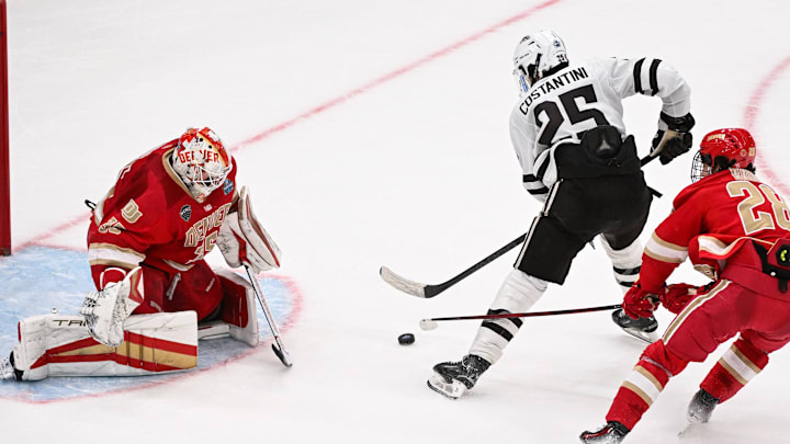 Apr 10, 2025; St. Louis, Missouri, UNITED STATES; goaltender Matt Davis (35) and Denver Pioneers defenseman Zeev Buium (28) defend the net against Western Michigan Broncos forward Matteo Costantini (25) during the second period of the Frozen Four college ice hockey national semifinals at Enterprise Center. 