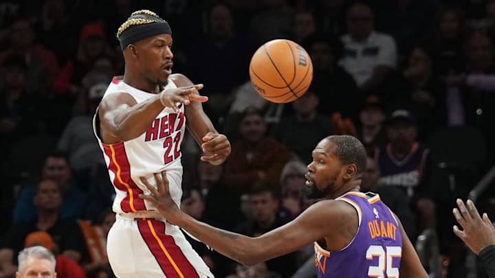 Nov 6, 2024; Phoenix, Arizona, USA; Miami Heat forward Jimmy Butler (22) passes the ball by Phoenix Suns forward Kevin Durant (35) to Miami Heat center Bam Adebayo (13) during the first half at Footprint Center. Mandatory Credit: Joe Camporeale-Imagn Images