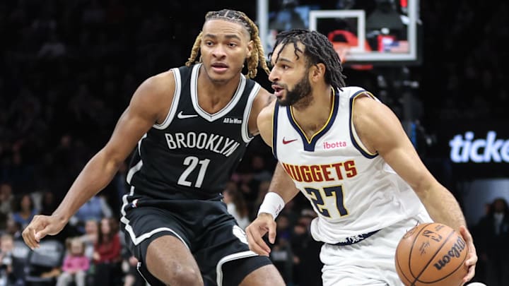 Jan 4, 2026; Brooklyn, New York, USA; Denver Nuggets guard Jamal Murray (27) drives past Brooklyn Nets forward Noah Clowney (21) in the first quarter at Barclays Center. Jan 4, 2026; Brooklyn, New York, USA; Denver Nuggets guard Jamal Murray (27) drives past Brooklyn Nets forward Noah Clowney (21) in the first quarter at Barclays Center.