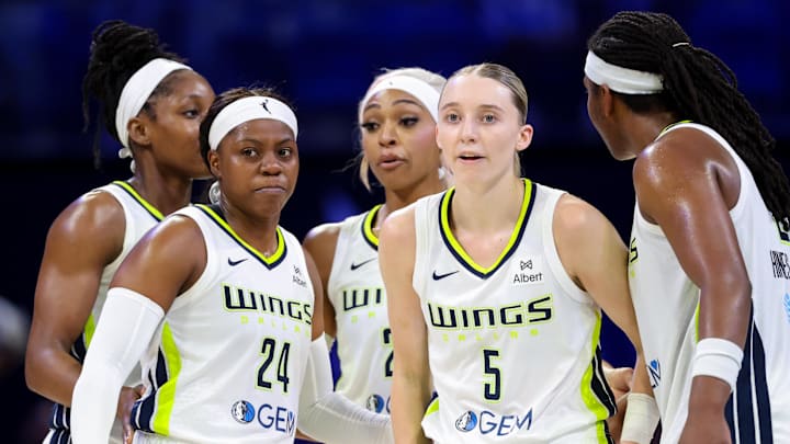 Jun 17, 2025; Arlington, Texas, USA;  Dallas Wings guard Paige Bueckers (5) and Dallas Wings guard Arike Ogunbowale (24) celebrates with teammates during the second half against the Golden State Valkyries at College Park Center. Mandatory Credit: Kevin Jairaj-Imagn Images