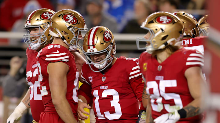Dec 30, 2024; Santa Clara, California, USA; San Francisco 49ers quarterback Brock Purdy (13) is congratulated by teammates after scoring a touchdown during the second quarter against the Detroit Lions at Levi's Stadium. Mandatory Credit: Sergio Estrada-Imagn Images