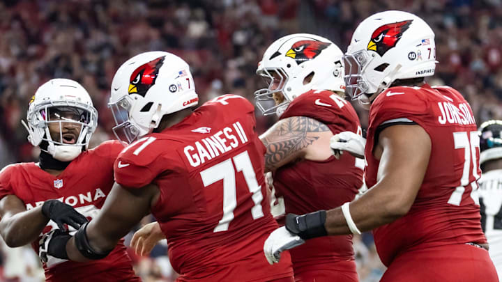 Nov 23, 2025; Glendale, Arizona, USA; Arizona Cardinals running back Bam Knight (20) celebrates a touchdown with offensive lineman Jon Gaines II (71), Hjalte Froholdt (72) and Paris Johnson Jr. (70) against the Jacksonville Jaguars at State Farm Stadium. Mandatory Credit: Mark J. Rebilas-Imagn Images Nov 23, 2025; Glendale, Arizona, USA; Arizona Cardinals running back Bam Knight (20) celebrates a touchdown with offensive lineman Jon Gaines II (71), Hjalte Froholdt (72) and Paris Johnson Jr. (70) against the Jacksonville Jaguars at State Farm Stadium. Mandatory Credit: Mark J. Rebilas-Imagn Images