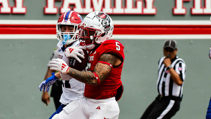 Sep 14, 2024; Raleigh, North Carolina, USA; North Carolina State Wolfpack wide receiver Noah Rogers (5) scores a touchdown against the Louisiana Tech Bulldogs during the second half at Carter-Finley Stadium. Mandatory Credit: Jaylynn Nash-Imagn Images