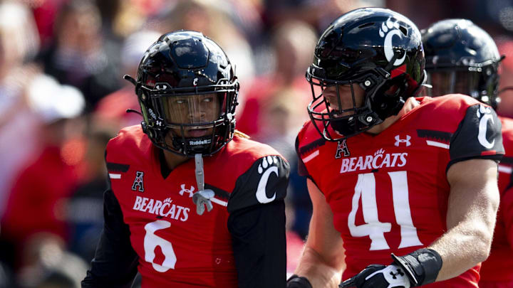 Oct 16, 2021; Cincinnati, Ohio, USA; Cincinnati Bearcats safety Bryan Cook (6) and Cincinnati Bearcats linebacker Joel Dublanko (41) celebrates after a third down stop in the first half of the NCAA football game between the Cincinnati Bearcats and the UCF Knights at Nippert Stadium. Mandatory Credit: Albert Cesare / The Enquirer-Imagn Images