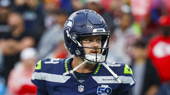 Seattle Seahawks quarterback Sam Darnold reacts following a rushing touchdown by a teammate.