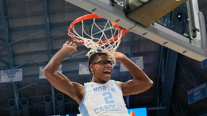 Feb 19, 2025; Chapel Hill, North Carolina, USA; North Carolina Tar Heels forward James Brown (2) scores as North Carolina State Wolfpack guard Dontrez Styles (3) defends in the second half at Dean E. Smith Center. Mandatory Credit: Bob Donnan-Imagn Images