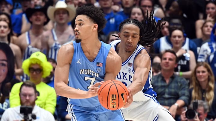 Mar 7, 2026; Durham, North Carolina, USA;Duke Blue Devils forward Maliq Brown (6) pokes the ball away from North Carolina Tar Heels guard Seth Trimble (7) during the second half at Cameron Indoor Stadium.  The Duke Blue Devils won 76-61. Mandatory Credit: Rob Kinnan-Imagn Images