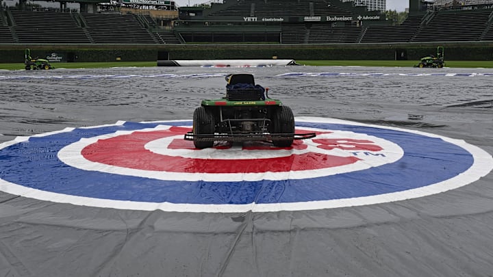 Jun 18, 2025; Chicago, Illinois, USA;  The tarp covers the field  before the weather cancelled game between the Chicago Cubs and the Milwaukee Brewers at Wrigley Field. Mandatory Credit: Matt Marton-Imagn Images