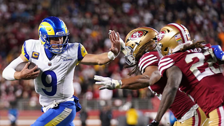 Dec 12, 2024; Santa Clara, California, USA; Los Angeles Rams quarterback Matthew Stafford (9) runs with the ball as San Francisco 49ers linebacker Fred Warner (54) defends in the fourth quarter at Levi's Stadium. Mandatory Credit: Cary Edmondson-Imagn Images
