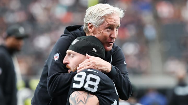 Sep 28, 2025; Paradise, Nevada, USA; Las Vegas Raiders defensive end Maxx Crosby (98) hugs head coach Pete Carroll prior to the game against the Chicago Bears at Allegiant Stadium. Mandatory Credit: Kiyoshi Mio-Imagn Images