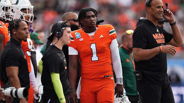 Dec 28, 2024; Orlando, FL, USA; Miami Hurricanes quarterback Cam Ward (1) stands on the sideline during the first half against the Iowa State Cyclones at Camping World Stadium. Mandatory Credit: Jasen Vinlove-Imagn Images