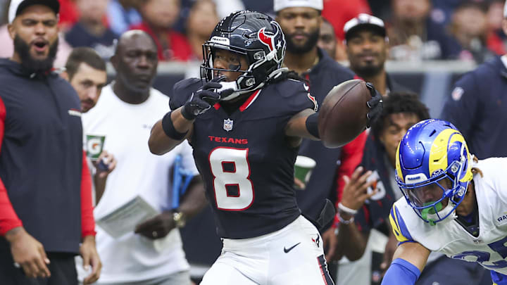 Aug 24, 2024; Houston, Texas, USA; Houston Texans wide receiver John Metchie III (8) runs with the ball as Los Angeles Rams safety Jason Taylor II (25) attempts to make a tackle during the first quarter at NRG Stadium. Mandatory Credit: Troy Taormina-Imagn Images