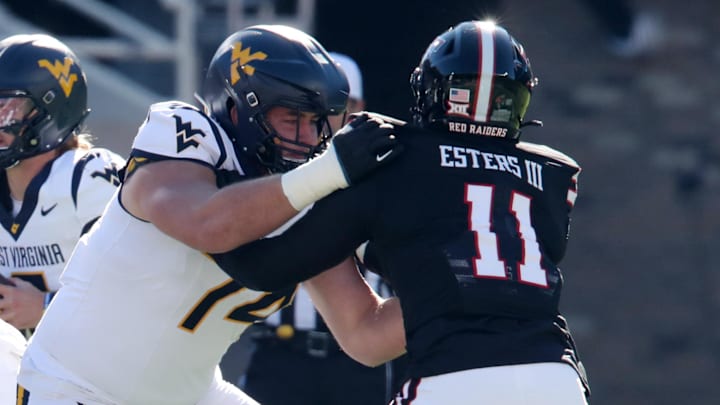 Nov 30, 2024; Lubbock, Texas, USA;  West Virginia Mountaineers offensive lineman Wyatt Milum (74) blocks Texas Tech Red Raiders defensive back Charles Esters III (11) in the first half at Jones AT&T Stadium and Cody Campbell Field. Mandatory Credit: Michael C. Johnson-Imagn Images