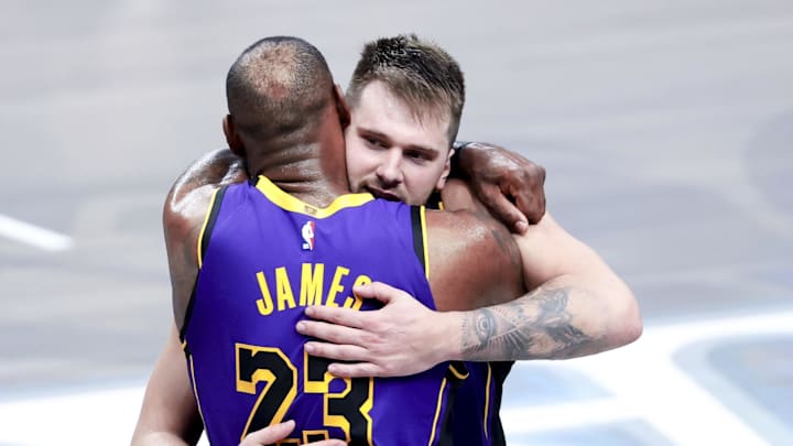 Los Angeles Lakers guard Luka Doncic (77) celebrates with Los Angeles Lakers forward LeBron James (23) during the fourth quarter against the Dallas Mavericks at American Airlines Center.