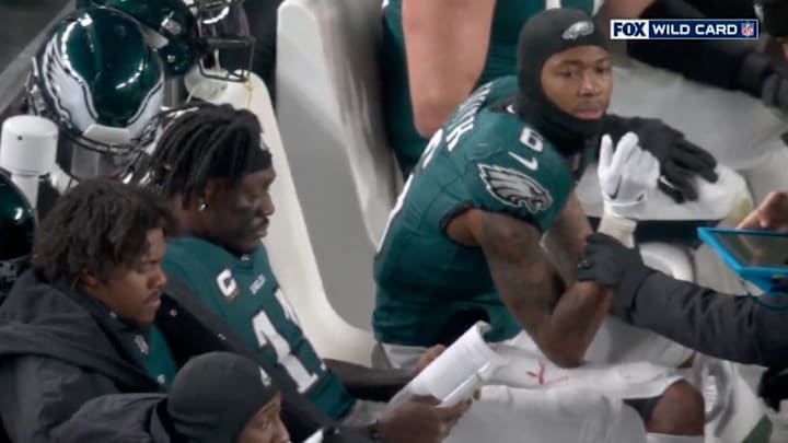 Philadelphia Eagles wide receiver A.J. Brown reading on bench during game vs. Green Bay Packers on Jan. 12, 2024. Philadelphia Eagles wide receiver A.J. Brown reading on bench during game vs. Green Bay Packers on Jan. 12, 2024.