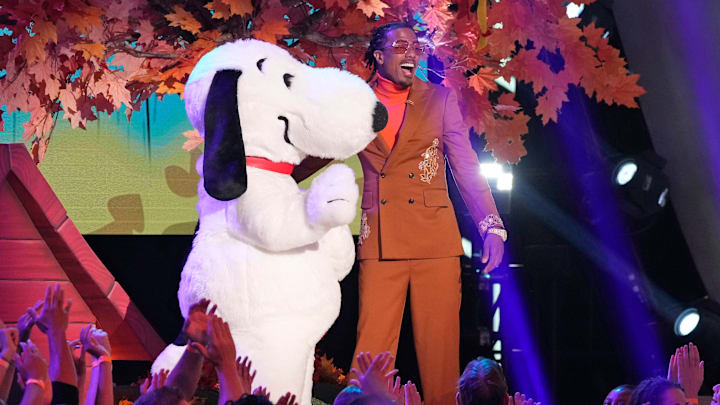 THE MASKED SINGER: L-R: Peanuts character Snoopy with Nick Cannon in the “Peanuts Night” episode of THE MASKED SINGER airing Thursday, Nov. 28 (8:00-9:02 PM ET/PT) on FOX.