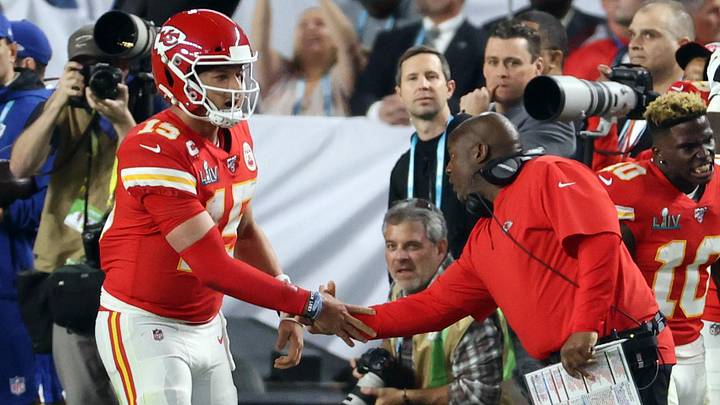 Feb 2, 2020; Miami Gardens, Florida, USA; Kansas City Chiefs quarterback Patrick Mahomes (15) shakes hands with offensive coordinator Eric Bieniemy after a first quarter touchdown against the San Francisco 49ers in Super Bowl LIV at Hard Rock Stadium. Mandatory Credit: Geoff Burke-Imagn Images