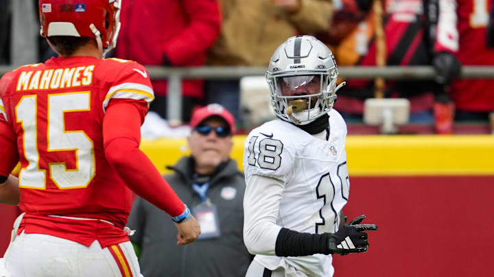 Dec 25, 2023; Kansas City, Missouri, USA; Las Vegas Raiders cornerback Jack Jones (18) returns an interception for a touchdown against Kansas City Chiefs quarterback Patrick Mahomes (15) during the first half at GEHA Field at Arrowhead Stadium. Mandatory Credit: Jay Biggerstaff-Imagn Images