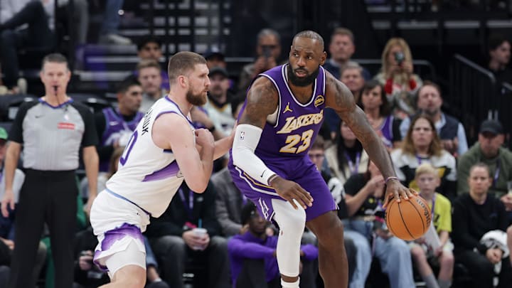 Dec 18, 2025; Salt Lake City, Utah, USA;  Los Angeles Lakers forward Lebron James (23) dribbles against Utah Jazz center Jusuf Nurkic (30) during the second half at Delta Center. Mandatory Credit: Chris Nicoll-Imagn Images