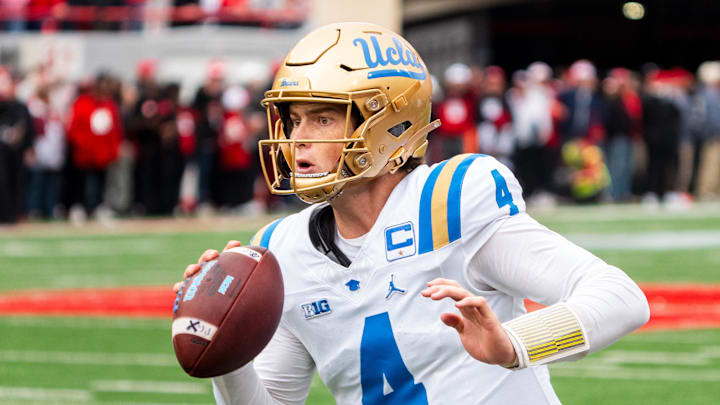Nov 2, 2024; Lincoln, Nebraska, USA; UCLA Bruins quarterback Ethan Garbers (4) scrambles out of bounds against the Nebraska Cornhuskers during the first quarter at Memorial Stadium. Mandatory Credit: Dylan Widger-Imagn Images