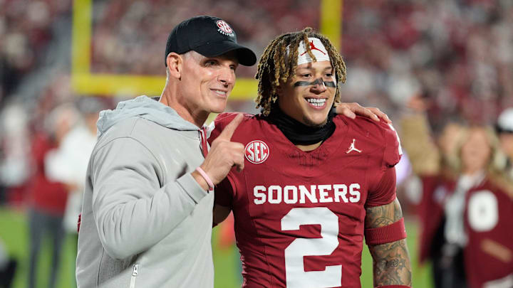 Oklahoma coach Brent Venables poses with defensive back Billy Bowman on Senior Night.