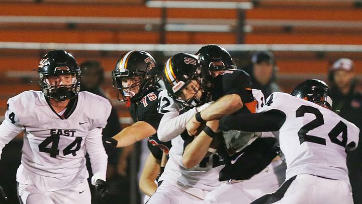 Ames' quarterback Cameron Cantonwine (11) battle for a few yard for a first down after getting tackled bu Sioux City East's defensive line James Hogancamp (42) and linebacker Jacob Breyfogle (24) during the first quarter at Ames High Football field on Friday, Oct. 13, 2023, in Ames, Iowa. Ames' quarterback Cameron Cantonwine (11) battle for a few yard for a first down after getting tackled bu Sioux City East's defensive line James Hogancamp (42) and linebacker Jacob Breyfogle (24) during the first quarter at Ames High Football field on Friday, Oct. 13, 2023, in Ames, Iowa.