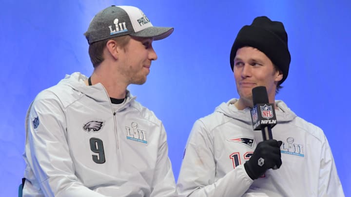 Jan 29, 2018; St. Paul, MN, USA; Philadelphia Eagles quarterback Nick Foles (9) and New England Patriots quarterback Tom Brady (12) are interviewed on stage during Super Bowl LII Opening Night at Xcel Energy Center. Mandatory Credit: Kirby Lee-Imagn Images