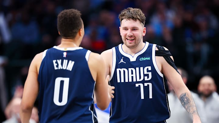 Dec 23, 2023; Dallas, Texas, USA;  Dallas Mavericks guard Luka Doncic (77) celebrates with Dallas Mavericks guard Dante Exum (0) during the second half against the San Antonio Spurs at American Airlines Center. Mandatory Credit: Kevin Jairaj-Imagn Images
