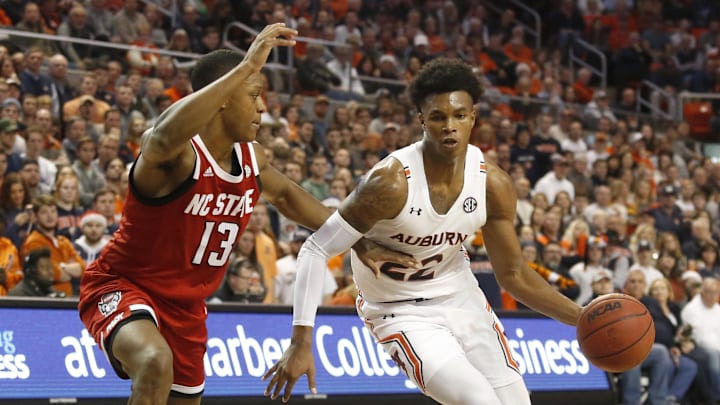 Dec 19, 2019; Auburn, AL, USA; North Carolina State Wolfpack guard C.J. Bryce (13) defends Auburn Tigers guard Allen Flanigan (22) during the second half at Auburn Arena. Mandatory Credit: John Reed-Imagn Images