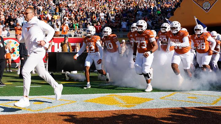 Texas Longhorns head coach Steve Sarkisian, Texas Longhorns wide receiver Parker Livingstone (13) and offensive lineman Brandon Baker (73) run onto the field before a game against the Michigan Wolverines at Camping World Stadium. Texas Longhorns head coach Steve Sarkisian, Texas Longhorns wide receiver Parker Livingstone (13) and offensive lineman Brandon Baker (73) run onto the field before a game against the Michigan Wolverines at Camping World Stadium.