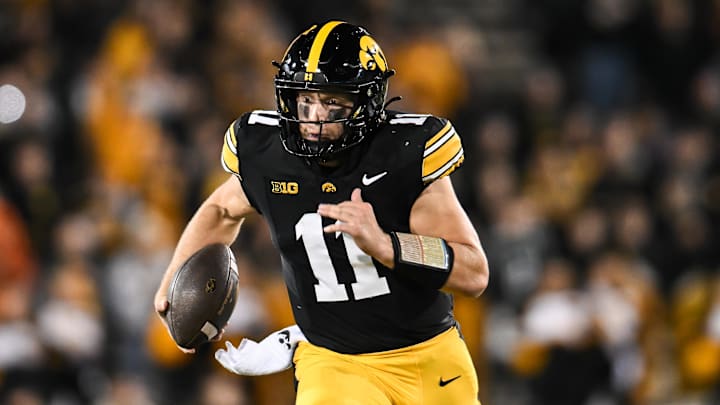 Nov 22, 2025; Iowa City, Iowa, USA; Iowa Hawkeyes quarterback Mark Gronowski (11) scrambles for yards against the Michigan State Spartans during the fourth quarter at Kinnick Stadium. Mandatory Credit: Jeffrey Becker-Imagn Images