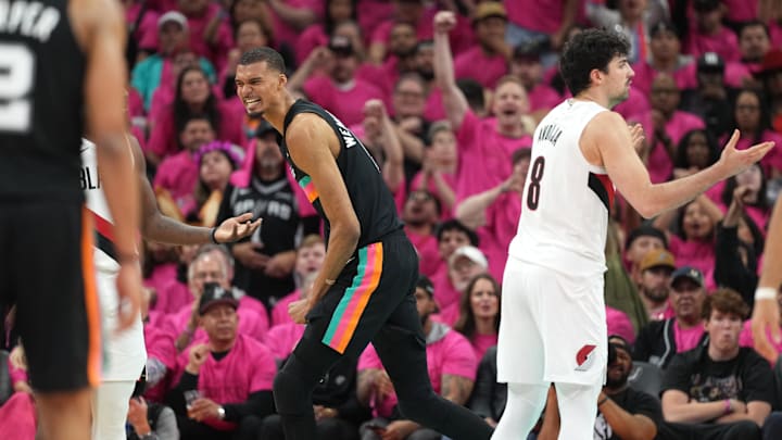 Apr 19, 2026; San Antonio, Texas, USA; San Antonio Spurs forward Victor Wembanyama (1) reacts after drawing a foul while scoring a basket during the second half of Game 1 of the first round of the 2026 NBA Playoffs against the Portland Trail Blazers at Frost Bank Center.