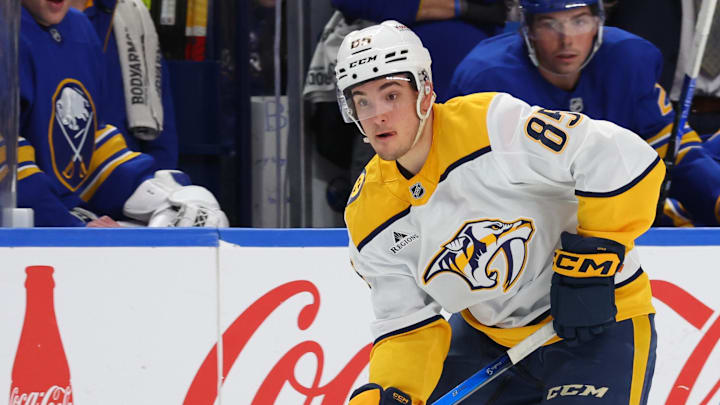 Mar 7, 2026; Buffalo, New York, USA;  Nashville Predators defenseman Ryan Ufko (85) looks to make a pass as Buffalo Sabres defenseman Zach Metsa (73) defends during the third period at KeyBank Center. Mandatory Credit: Timothy T. Ludwig-Imagn Images