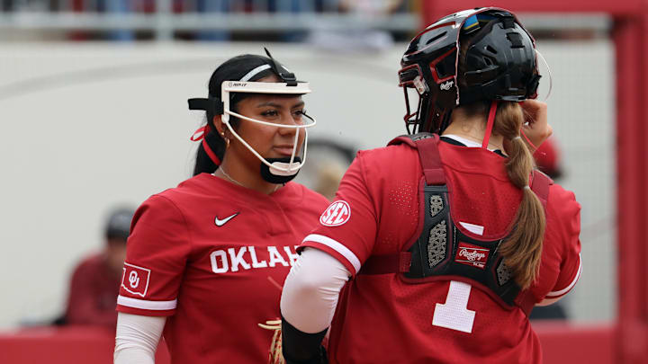 Miali Guachino talks with catcher Kendall Wells in one of Oklahoma's contests against Kentucky at Love's Field.
