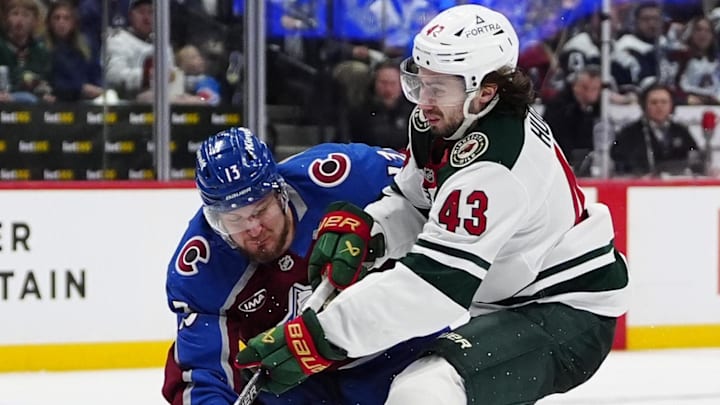 May 3, 2026; Denver, Colorado, USA; Colorado Avalanche right wing Valeri Nichushkin (13) defends a shot on goal by Minnesota Wild defenseman Quinn Hughes (43) during the third period in game one of the second round of the 2026 Stanley Cup Playoffs at Ball Arena. Mandatory Credit: Ron Chenoy-Imagn Images