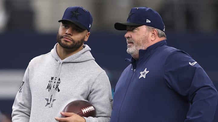 Dallas Cowboys quarterback Dak Prescott and coach Mike McCarthy talk on the sidelines during a game.
