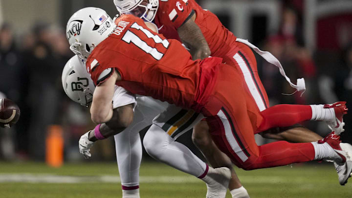 Oct 25, 2025; Cincinnati, Ohio, USA;  Baylor Bears tight end Michael Trigg (1) is unable to hold on to a catch as he is tackled by Cincinnati Bearcats linebacker Jake Golday (11) and defensive back Tre Gola-Callard (6) in the second half at Nippert Stadium. Mandatory Credit: Aaron Doster-Imagn Images