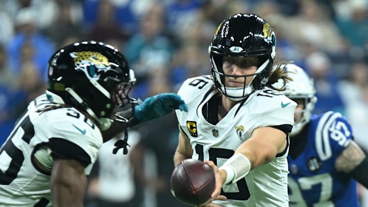 Dec 28, 2025; Indianapolis, Indiana, USA; Jacksonville Jaguars quarterback Trevor Lawrence (16) hands off to running back Lequint Allen Jr. (36) during the first half against the Indianapolis Colts at Lucas Oil Stadium. Mandatory Credit: Robert Goddin-Imagn Images