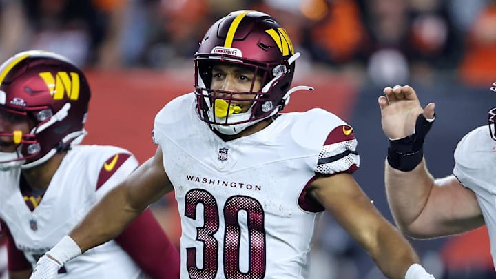 Sep 23, 2024; Cincinnati, Ohio, USA; Washington Commanders running back Austin Ekeler (30) celebrates his touchdown with quarterback Jayden Daniels (left) and center Tyler Biadasz (63) during the first quarter against the Cincinnati Bengals at Paycor Stadium. Mandatory Credit: Joseph Maiorana-Imagn Images Sep 23, 2024; Cincinnati, Ohio, USA; Washington Commanders running back Austin Ekeler (30) celebrates his touchdown with quarterback Jayden Daniels (left) and center Tyler Biadasz (63) during the first quarter against the Cincinnati Bengals at Paycor Stadium. Mandatory Credit: Joseph Maiorana-Imagn Images