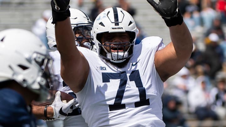 Penn State offensive lineman Vega Ioane (71) celebrates with running back Quinton Martin after the freshman scored a touchdown during the Blue-White game at Beaver Stadium on Saturday, April 13, 2024, in State College. The White team defeated the Blue team, 27-0.