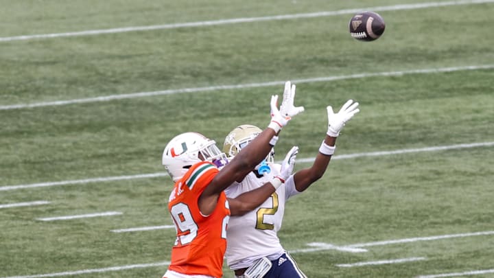 Nov 9, 2024; Atlanta, Georgia, USA; Miami Hurricanes defensive back OJ Frederique Jr. (29) breaks up a pass intended for Georgia Tech Yellow Jackets wide receiver Eric Singleton Jr. (2) in the second quarter at Bobby Dodd Stadium at Hyundai Field. Mandatory Credit: Brett Davis-Imagn Images Nov 9, 2024; Atlanta, Georgia, USA; Miami Hurricanes defensive back OJ Frederique Jr. (29) breaks up a pass intended for Georgia Tech Yellow Jackets wide receiver Eric Singleton Jr. (2) in the second quarter at Bobby Dodd Stadium at Hyundai Field. Mandatory Credit: Brett Davis-Imagn Images