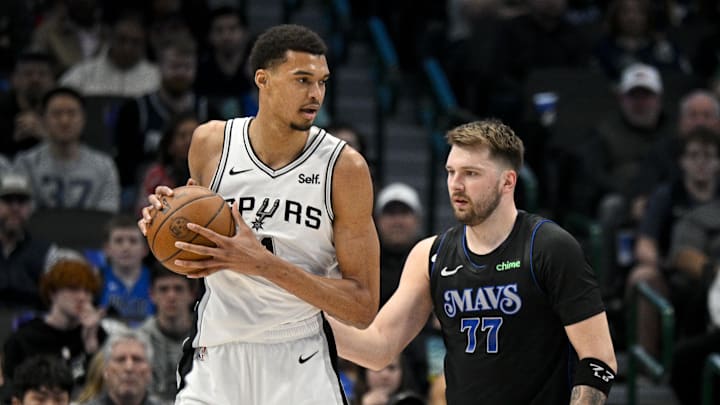 Feb 14, 2024; Dallas, Texas, USA; San Antonio Spurs center Victor Wembanyama (1) looks to move the ball past Dallas Mavericks guard Luka Doncic (77) during the fist quarter at the American Airlines Center. Mandatory Credit: Jerome Miron-Imagn Images