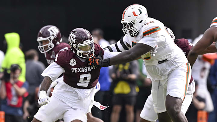 Texas A&M Aggies defensive end Cashius Howell (9) rushes the line past Miami Hurricanes offensive lineman Markel Bell (70) during the game between the Aggies and the Hurricanes at Kyle Field.